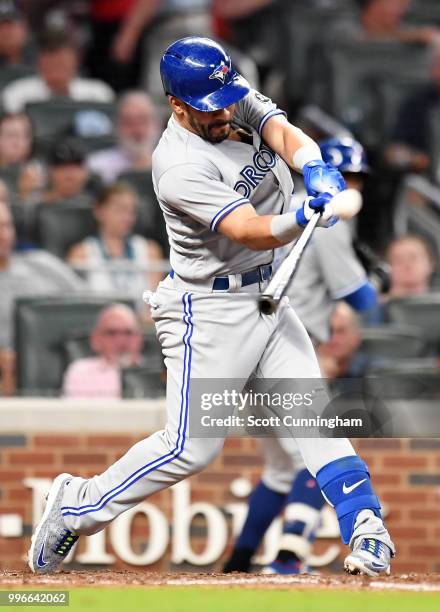 Devon Travis of the Toronto Blue Jays hits a grand slam in the seventh inning against the Atlanta Braves at SunTrust Park on July 11, 2018 in...