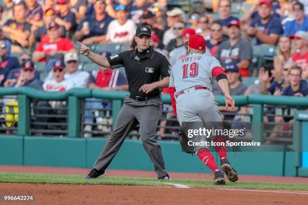 First base umpire Quinn Wolcott signals fair ball as a ball hit by Cleveland Indians left fielder Michael Brantley gets past Cincinnati Reds first...