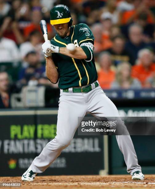 Stephen Piscotty of the Oakland Athletics is hit by a pitch in the fifth inning against the Oakland Athletics at Minute Maid Park on July 11, 2018 in...