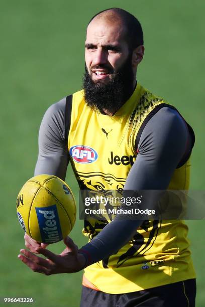 Bachar Houli of the Tigers, tipped by coach Damien Hardwick to return, handballs during a Richmond Tigers AFL training session at Punt Road Oval on...