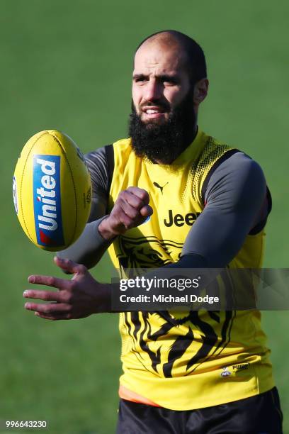 Bachar Houli of the Tigers, tipped by coach Damien Hardwick to return, handballs during a Richmond Tigers AFL training session at Punt Road Oval on...