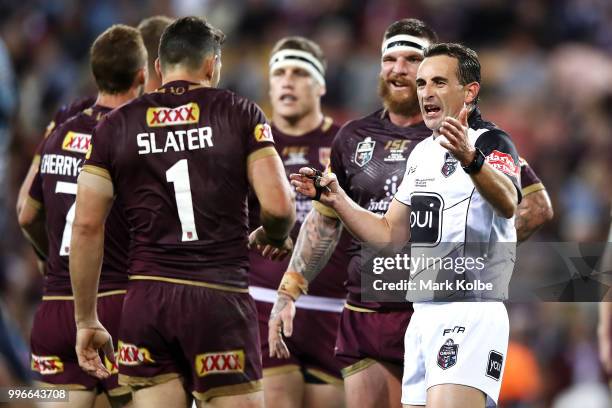 Referee Gerard Sutton speaks to Billy Slater of Queensland during the round 10 Super Netball match between the Giants and the Swifts at the...