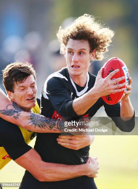 Brody Mihocek of the Magpies tackles Chris Mayne of the Magpies Nathan Buckley speaks to the media during a Collingwood Magpies AFL press conference...