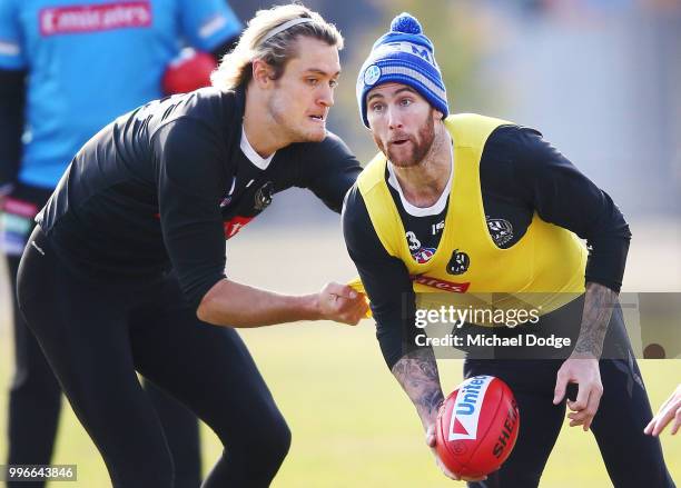 Darcy Moore of the Magpies tackles Jeremy Howe of the Magpies during a Collingwood Magpies AFL training session at the Holden Centre on July 12, 2018...