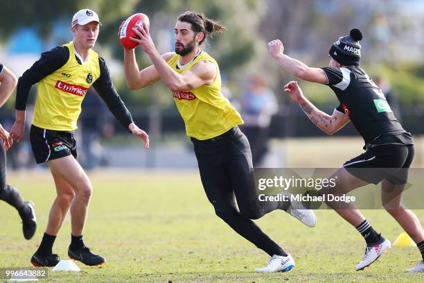 Brodie Grundy of the Magpies runs with the ball during a Collingwood Magpies AFL training session at the Holden Centre on July 12, 2018 in Melbourne,...