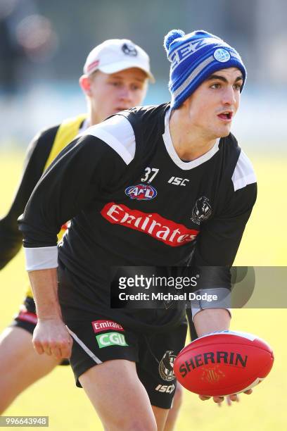 Brayden Maynard of the Magpies handballs during a Collingwood Magpies AFL press conference at the Holden Centre on July 12, 2018 in Melbourne,...