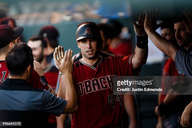 Paul Goldschmidt of the Arizona Diamondbacks is congratulated in the dugout after hitting a solo home run during the first inning against the...