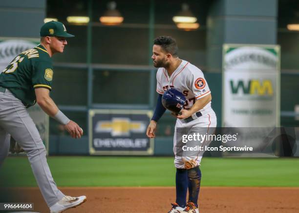 Houston Astros second baseman Jose Altuve challenges Oakland Athletics third baseman Matt Chapman after taking a slide during the baseball game...