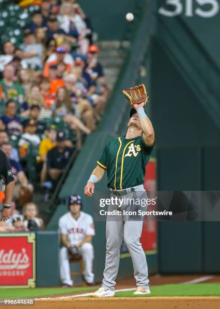 Oakland Athletics third baseman Matt Chapman catches a pop fly hit by Houston Astros designated hitter Evan Gattis in the bottom of the fifth inning...