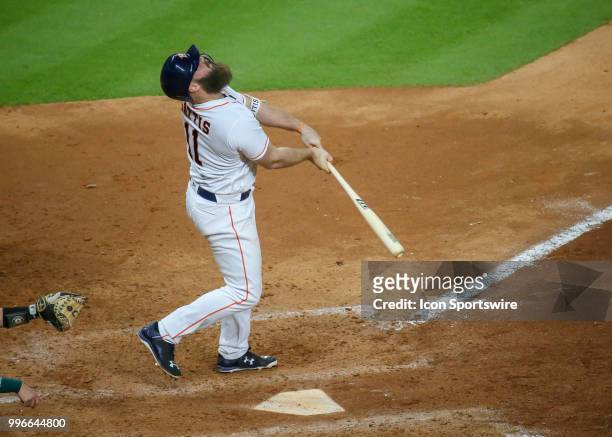 Houston Astros designated hitter Evan Gattis watches his hit in the bottom of the seventh inning during the baseball game between the Oakland...