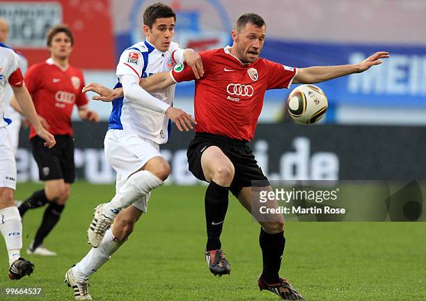 Fin Bartels of Rostock and Fabian Gerber of Ingolstadt compete for the ball during the Second Bundesliga play off leg two match between Hansa Rosotck...