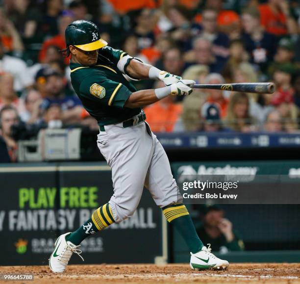 Khris Davis of the Oakland Athletics triples in the sixth inning against the Houston Astros at Minute Maid Park on July 11, 2018 in Houston, Texas.