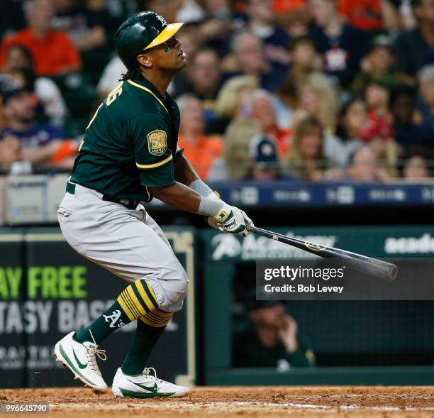 Khris Davis of the Oakland Athletics triples in the sixth inning against the Houston Astros at Minute Maid Park on July 11, 2018 in Houston, Texas.