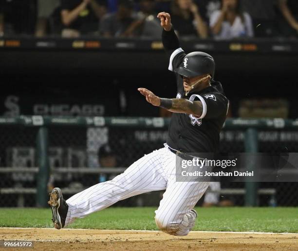 Omar Narvaez of the Chicago White Sox slides in to score a run in the 7th inning against the St. Louis Cardinals at Guaranteed Rate Field on July 11,...