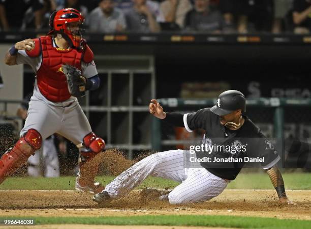 Omar Narvaez of the Chicago White Sox slides in to score a run in the 7th inning as Yadier Molina of the St. Louis Cardinals takes the late throw at...