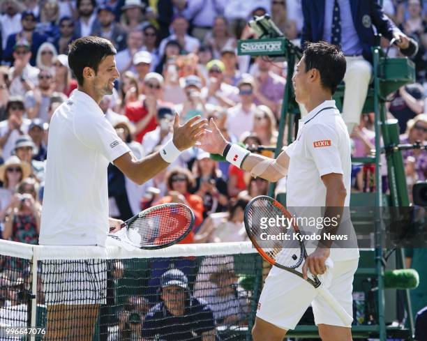 Novak Djokovic of Serbia shakes hands with Kei Nishikori of Japan after his victory in the quarterfinals at Wimbledon in London on July 11, 2018....