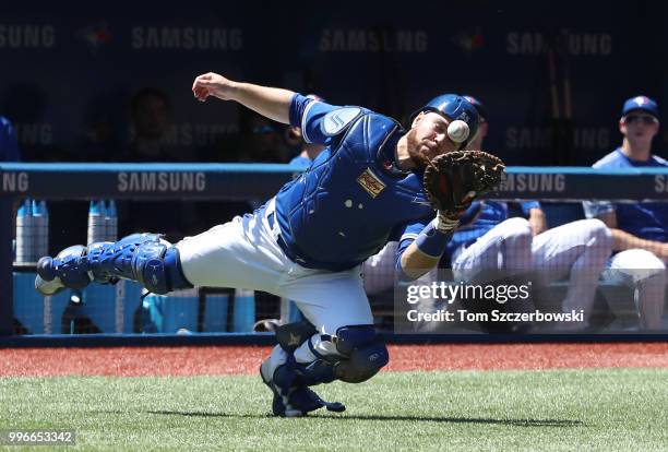 Russell Martin of the Toronto Blue Jays momentarily bobbles a foul pop up but holds on to the baseball for the catch in the first inning during MLB...