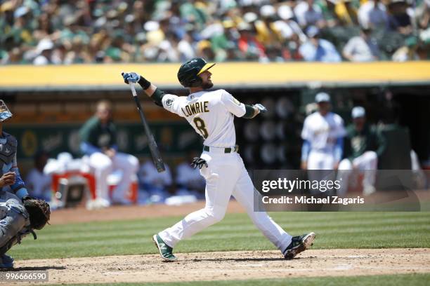 Jed Lowrie of the Oakland Athletics bats during the game against the Los Angeles Angels of Anaheim at the Oakland Alameda Coliseum on June 17, 2018...