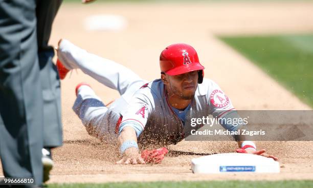 Andrelton Simmons of the Los Angeles Angels of Anaheim slides safely into third during the game against the Oakland Athletics at the Oakland Alameda...