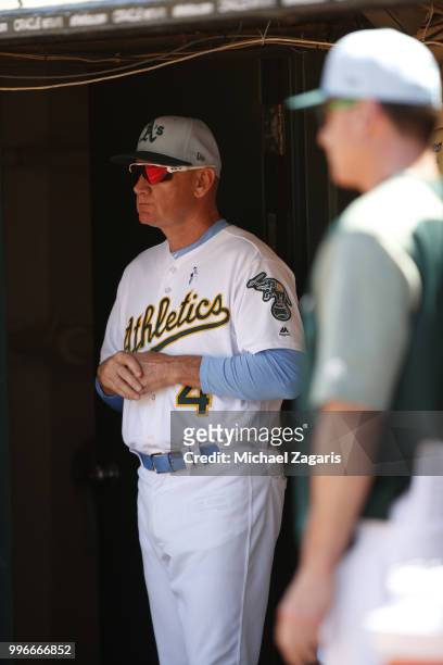 Third Base Coach Matt Williams of the Oakland Athletics stands in the dugout during the game against the Los Angeles Angels of Anaheim at the Oakland...