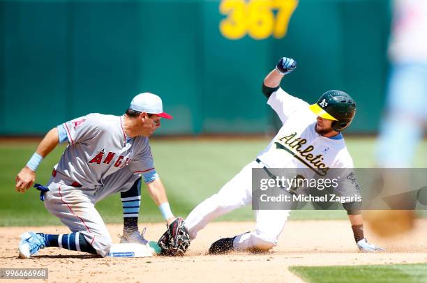 Jed Lowrie of the Oakland Athletics steals second during the game against the Los Angeles Angels of Anaheim at the Oakland Alameda Coliseum on June...