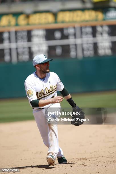 Jed Lowrie of the Oakland Athletics fields during the game against the Los Angeles Angels of Anaheim at the Oakland Alameda Coliseum on June 17, 2018...