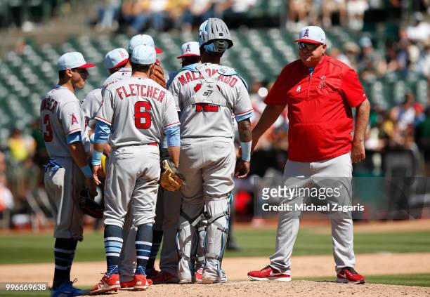 Manager Mike Scioscia of the Los Angeles Angels of Anaheim makes a pitching change during the game against the Oakland Athletics at the Oakland...