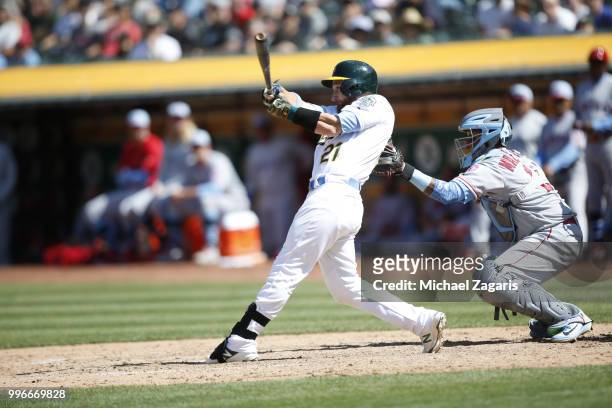 Jonathan Lucroy of the Oakland Athletics bats during the game against the Los Angeles Angels of Anaheim at the Oakland Alameda Coliseum on June 17,...