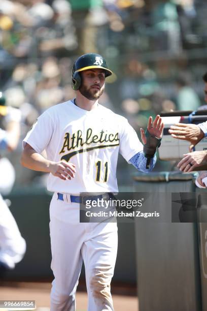 Dustin Fowler of the Oakland Athletics is congratulated at the dugout during the game against the Los Angeles Angels of Anaheim at the Oakland...