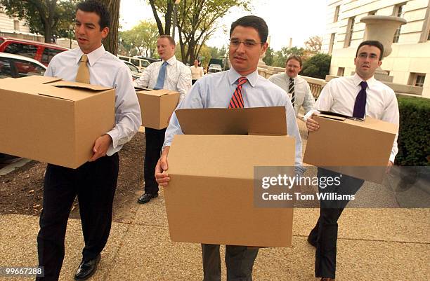 From left, Matt Dennis, Chris Hartmann, Chris Gaston, and Seth Tillman, from the office of Rep. Rush Holt, D-N.J., bring boxes of donated goods to be...