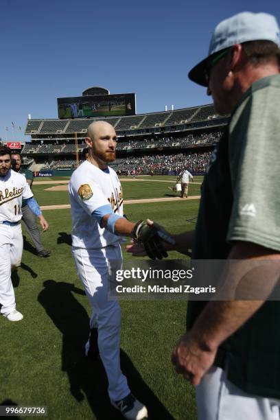 Jonathan Lucroy of the Oakland Athletics is congratulated by Manager Bob Melvin after hitting a walkoff single during the game against the Los...