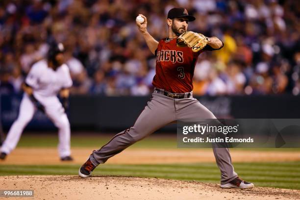 Relief pitcher Daniel Descalso of the Arizona Diamondbacks delivers to home plate during the fourth inning against the Colorado Rockies at Coors...