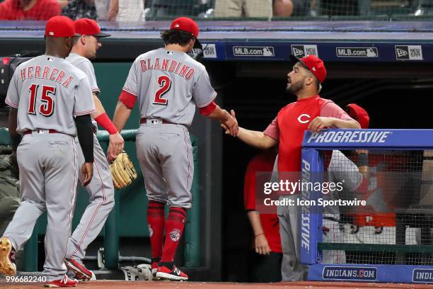 Cincinnati Reds infielder Alex Blandino is congratulated by Cincinnati Reds third baseman Eugenio Suarez after Blandino pitched the eighth inning of...