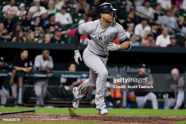Giancarlo Stanton of the New York Yankees hits a two RBI single during the ninth inning against the Baltimore Orioles at Oriole Park at Camden Yards...