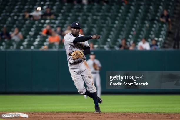 Didi Gregorius of the New York Yankees throws to first to retire Mark Trumbo of the Baltimore Orioles during the ninth inning at Oriole Park at...