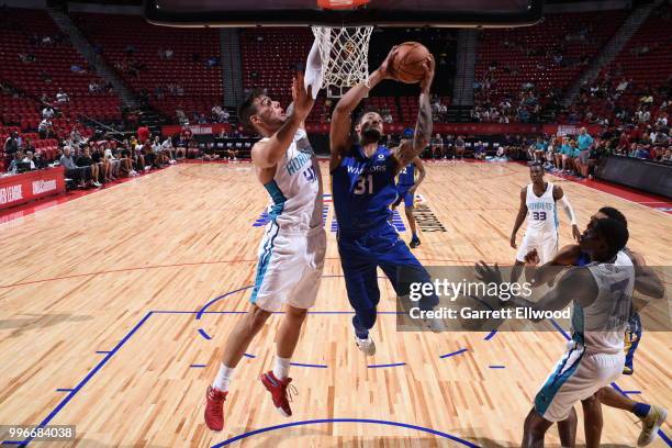 Tokoto of Golden State Warriors goes to the basket against the Willy Hernangomez of the Charlotte Hornets during the 2018 Las Vegas Summer League on...