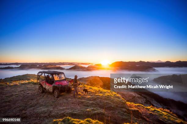 the blue duck lodge located in the whanganui national park is a working cattle farm with a focus on conservation. a buggy sits at the top of the mountain to watch the early morning fog as it floods the valley at sunrise. - dog overhead view stock pictures, royalty-free photos & images