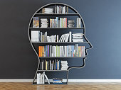 Head with a bookshelf in front of black wall