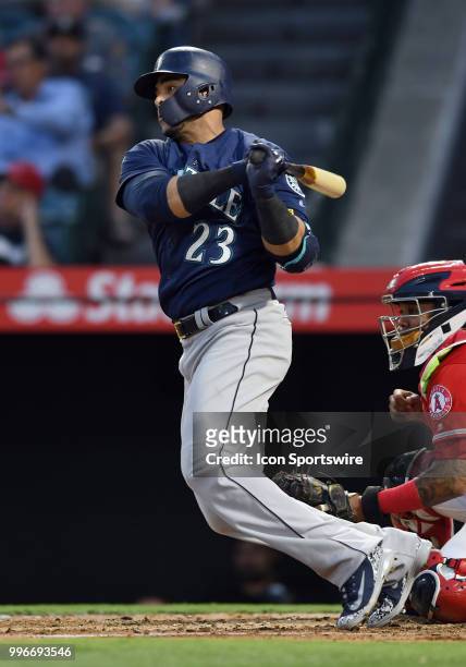 Seattle Mariners designated hitter Nelson Cruz hits a single and drives in two runs during the fourth inning of a game against the Los Angeles Angels...