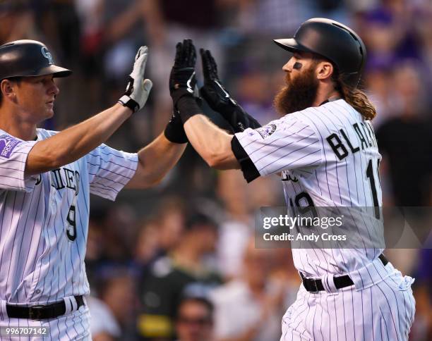 Colorado Rockies center fielder Charlie Blackmon celebrates his two-run home run with teammate that he brought home, Colorado Rockies second baseman...