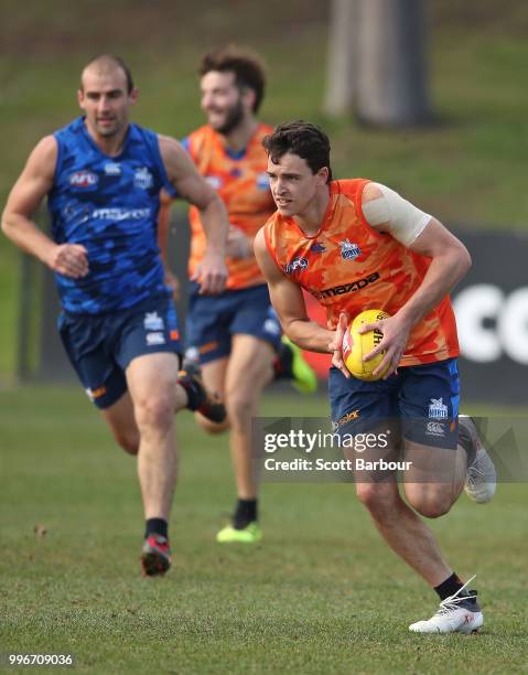 Luke Davies-Uniacke of the Kangaroos runs with the ball during a North Melbourne Kangaroos Training Session on July 12, 2018 in Melbourne, Australia.