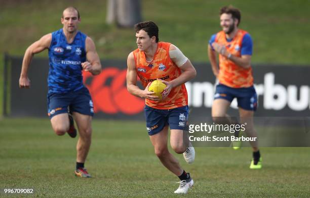 Luke Davies-Uniacke of the Kangaroos runs with the ball during a North Melbourne Kangaroos Training Session on July 12, 2018 in Melbourne, Australia.