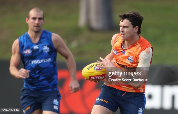 Luke Davies-Uniacke and Ben Cunnington of the Kangaroos compete for the ball during a North Melbourne Kangaroos Training Session on July 12, 2018 in...