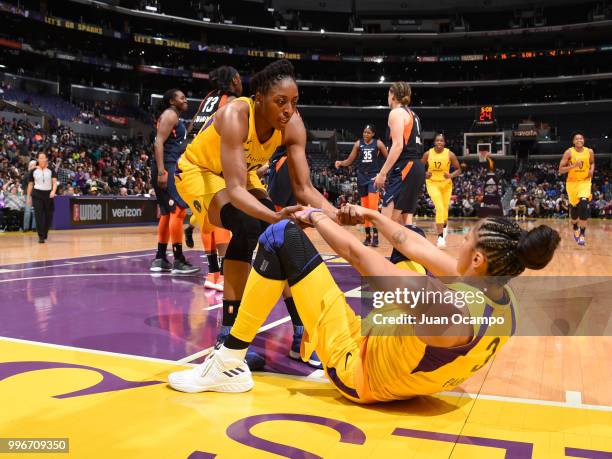 Nneka Ogwumike of the Los Angeles Sparks helps up Candace Parker of the Los Angeles Sparks during the game against the Connecticut Sun on July 3,...