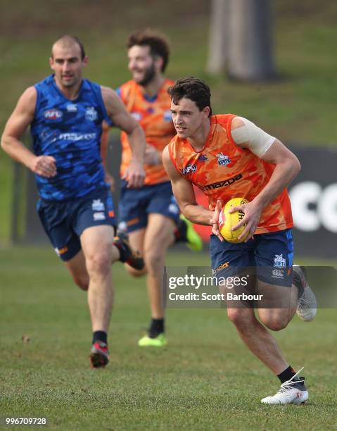 Luke Davies-Uniacke of the Kangaroos runs with the ball during a North Melbourne Kangaroos Training Session on July 12, 2018 in Melbourne, Australia.