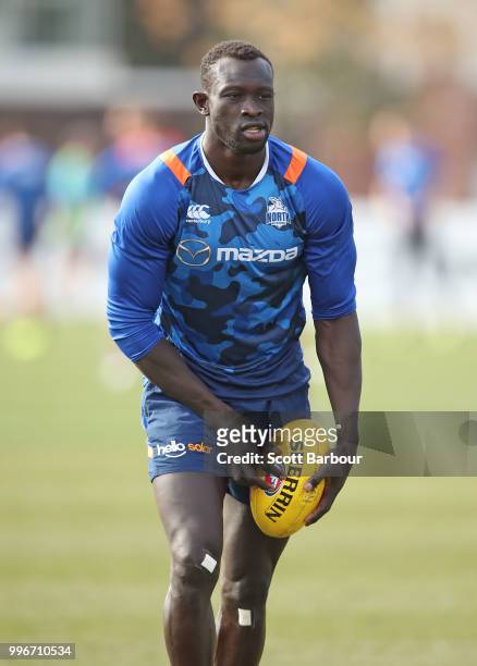 Majak Daw of the Kangaroos runs with the ball during a North Melbourne Kangaroos Training Session on July 12, 2018 in Melbourne, Australia.