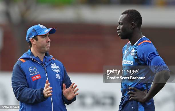 Brad Scott, coach of the Kangaroos talks to Majak Daw of the Kangaroos during a North Melbourne Kangaroos Training Session on July 12, 2018 in...