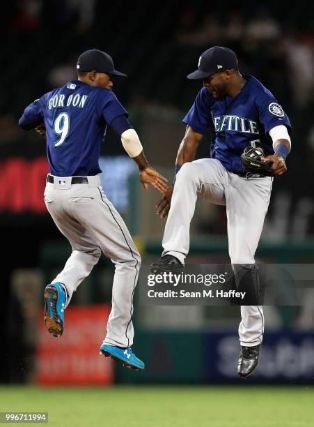 Dee Gordon and Guillermo Heredia of the Seattle Mariners celebrate defeating the Los Angeles Angels of Anaheim 3-0 in a game at Angel Stadium on July...