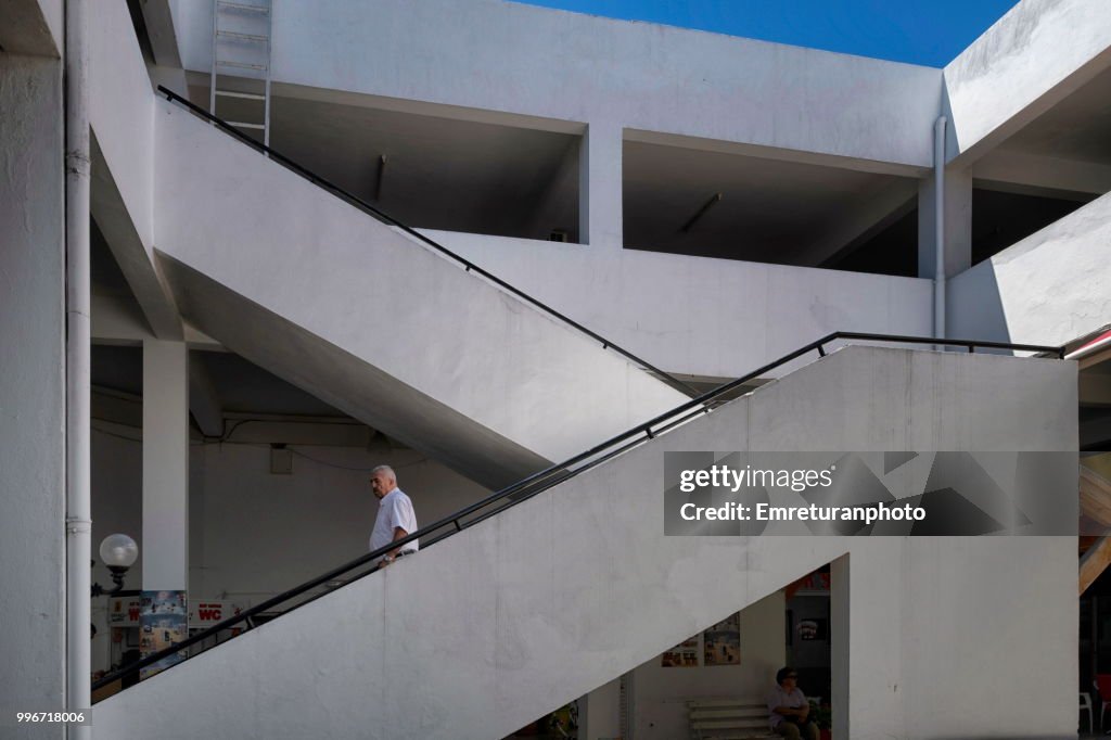Man walking down the stairs in an office building in Cesme.