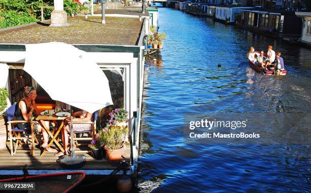 the most sunny and charming houseboat in amsterdam. - floating moored platform stock pictures, royalty-free photos & images